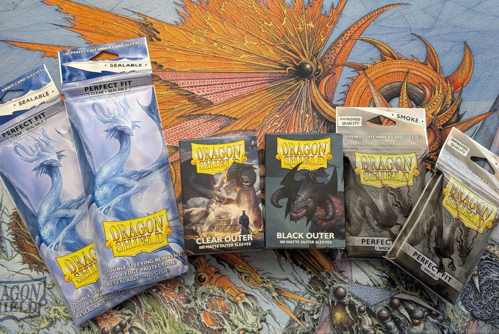 Double Sleeve Options from Dragon Shield. L to r: Perfect Fit Sealable, Clear Outer, Black Outer, Perfect Fit Smoke